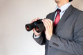 Businessman looking for something with binoculars - PhotoDune Item for Sale
