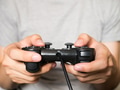 A young man holding game controller playing video games - PhotoDune Item for Sale