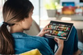 Woman Choosing Movie For Streaming On Tablet - PhotoDune Item for Sale