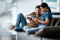 Young Man Helping Girlfriend With Phone App at Home - PhotoDune Item for Sale