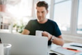 Laptop on table with man sitting by - PhotoDune Item for Sale