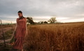 Woman strolling on wheat field with flowers - PhotoDune Item for Sale