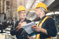 senior male worker training new young engineer employee working in heavy industry metal factory - PhotoDune Item for Sale