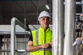 Factory engineer male worker checking high pressure pipe guage in factory boiler room - PhotoDune Item for Sale