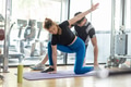 Healthy woman with personal trainer in Yoga or Pilates body slimming training class at sport club. - PhotoDune Item for Sale