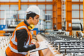Young male engineer supervisor working QC in metal sheet manufactory work checking production line. - PhotoDune Item for Sale