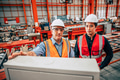 Young engineer standing with senior supervisor teamwork in metal factory happy worker team. - PhotoDune Item for Sale