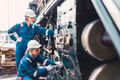 Train engineer team working service maintenance old dirty vintage classic steam engine locomotive in - PhotoDune Item for Sale