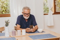 Senior elder old man happy to use smartphone watching or video calling at home - PhotoDune Item for Sale