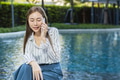 asian business woman middle age phone calling outdoor green nature pool background - PhotoDune Item for Sale