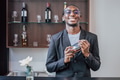 happy young smiling bartender in black people worker with cocktail shaker work in hotel luxury lobby - PhotoDune Item for Sale