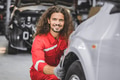 male staff worker work in auto workshop happy smiling enjoy working servicing car tire replace - PhotoDune Item for Sale