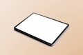 Blank tablet screen on beige background - PhotoDune Item for Sale