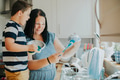 Mother teaching son how to do the dishes - PhotoDune Item for Sale