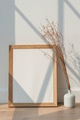 Dried white statice flower in a white vase by an empty wooden frame on a wooden floor - PhotoDune Item for Sale