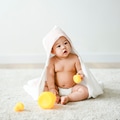 Baby in a bath towel with rubber ducks - PhotoDune Item for Sale