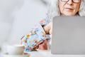 Social media networking background with senior woman working on a laptop - PhotoDune Item for Sale