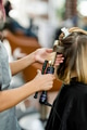 Woman getting her hair curled at a beauty salon - PhotoDune Item for Sale