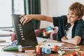Boy creating text on black letter board - PhotoDune Item for Sale