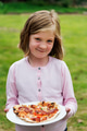 A little girl holding a plate of pizza - PhotoDune Item for Sale