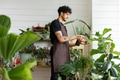 Man misting plants with a water spray - PhotoDune Item for Sale