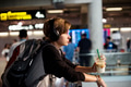 Young caucasian traveler holding drink beverage in the airport - PhotoDune Item for Sale