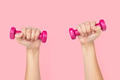 Hand holding dumbbells in health and wellness concept - PhotoDune Item for Sale
