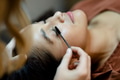Beautician giving eyelash treatment to a customer at a beauty salon - PhotoDune Item for Sale