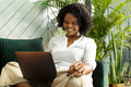Smiling woman during conference call on laptop working from home in the new normal - PhotoDune Item for Sale