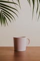 Earth tone color ceramic coffee cup on wooden table - PhotoDune Item for Sale