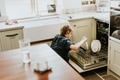 Boy putting dish to dishwasher, household chores for kids - PhotoDune Item for Sale
