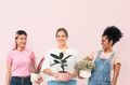 Happy women plant lovers holding potted houseplants - PhotoDune Item for Sale