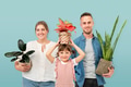 Happy family holding potted plants - PhotoDune Item for Sale
