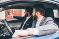 Two elegant contemporary bearded businessmen taking selfie seated in car - PhotoDune Item for Sale