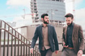 Two young businessmen outdoors walking stairs talking and chatting - PhotoDune Item for Sale