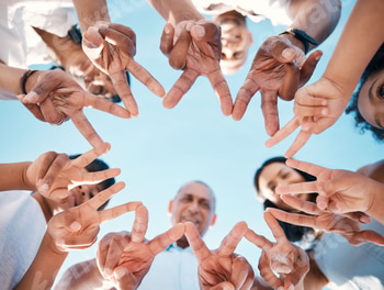 Peace, hands and people with star for team building, support and partnership from below. V sign, co