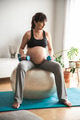 Pregnant woman doing exercises at home - PhotoDune Item for Sale