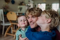 Two sons kissing father's cheeks. Concept of Father's Day, and fatherly love. - PhotoDune Item for Sale