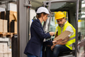 Forklift driver talking with manager in modern industrial factory. Warehouseman reading order, order - PhotoDune Item for Sale
