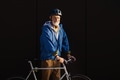 Elderly man, cyclist traveling through the city by bike. Vital senior city commuter riding a bike - PhotoDune Item for Sale