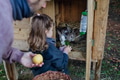 Girl and father feeding pet rabbit, giving it vegetables from the garden and old bread. - PhotoDune Item for Sale