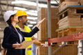 Female manager talking with foreman. Warehouse, production worker preparing products for shipment - PhotoDune Item for Sale