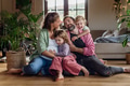 Portrait of young family at home. Pregnant mother with her children and husband in living room. - PhotoDune Item for Sale