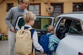 Children getting into the car, father taking them to school and kindergarten before going to work. - PhotoDune Item for Sale