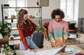 Young colleagues working together in startup company. - PhotoDune Item for Sale