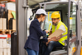 Forklift driver talking with manager in modern industrial factory. Warehouseman reading order, order - PhotoDune Item for Sale