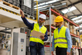 Engineer consulting with product manager in modern industrial factory, explaining new production - PhotoDune Item for Sale