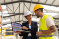 Female manager talking with foreman, checking production plan on notebook. Woman quality controller - PhotoDune Item for Sale