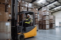 Multiracial warehouse worker driving forklift. Warehouse worker preparing products for shipmennt - PhotoDune Item for Sale