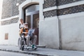 Granddaughter pushing senior man in wheelchair on street. Buying newspaper in newsstand. Female - PhotoDune Item for Sale